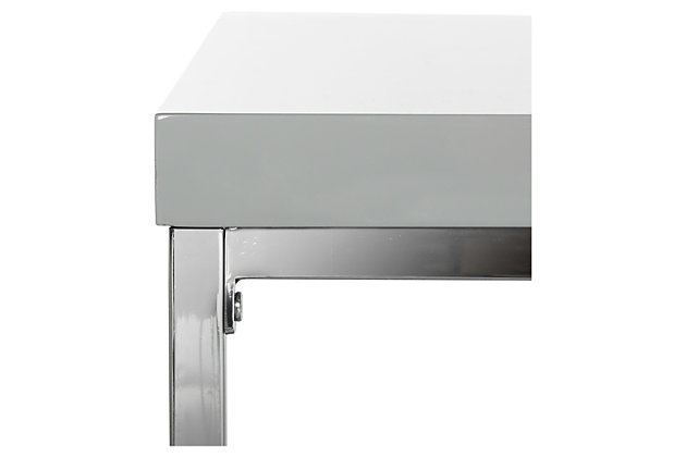 Take your love of minimalism to the max with the Malone coffee table. Its ultra-linear design merges a chrome-tone metal frame with a high-sheen lacquer look tabletop in gray. The result: the ultimate designer piece for lovers of contemporary style.Made of iron with chrome-tone finish | Engineered wood tabletop with gray lacquer look finish | Fixed clear glass shelf | Clean with a soft, dry cloth; spray small amount of glass cleaner onto lint-free cloth and wipe mirror/glass clean | Assembly required