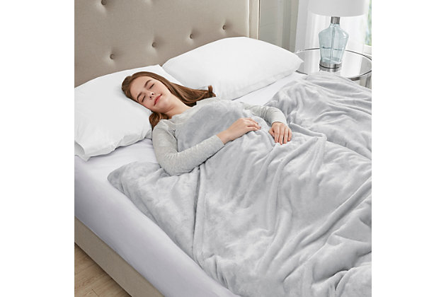 The Sleep Philosophy plush weighted blanket is a safe and effective remedy for anyone looking for a better night’s sleep or just to feel a little more relaxed after a stressful day at the office. The 60”x70” blanket distributes pressure all over your body, touching pressure points that can help reduce stress and anxiety. At the same time it creates a feeling of being held or hugged to make you feel secure and relaxed. The weighted insert is box-sewn to prevent the poly and glass bead filling from shifting during use. There are 10 ties inside the plush cover to secure the insert in place. Using a weighted blanket can help relax user's mind and in turn promote a deep and restful sleep throughout the night. This blanket can be used in many different ways by covering your whole body for sleep or simply wrap it around your shoulders or lay it across your lap or legs. Choose a blanket that’s around 10% of your body weight, available in 12 or 18 pound size. The plush cover with a zipper closure is removable for easy machine washing.Imported | Provides all over body comforting pressure, making you feel secure and relaxed | Weighted blanket designed for adults or minimum body weight of 120 lbs or more | Poly fill and glass beads fillig weight to promote a deep and restful sleep throughout the night | Removable plush cover zipper closure is machine washable for easy care | 10 inside ties efficiently stay put the weighted insert | Available in 12 lb and 18 lb weights