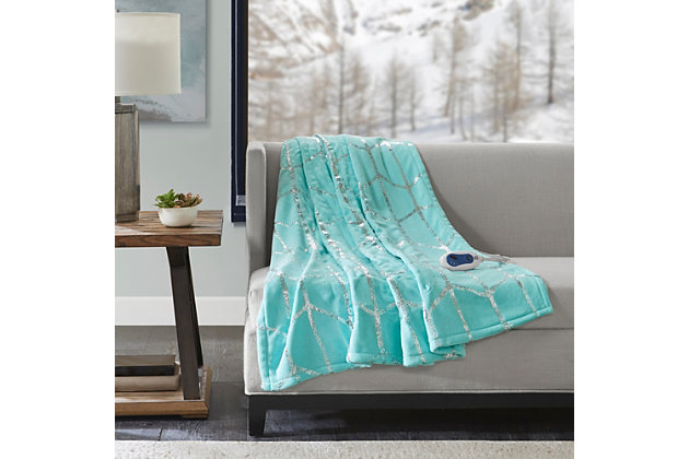 True North by Sleep Philosophy offers incredible comfort and style with the Raina Heated Metallic Print Throw. A silver metallic geometric design is beautifully printed on an ultra-soft plush aqua base fabric. Emitting virtually no electromagnetic field emissions, this throw features three heat settings and a 2-hour shut-off timer to provide the perfect amount of warmth and comfort. Bundle up in comfort and add a casual touch with a glamorous flair to your home with this heated metallic print throw. Includes manufacturer’s 5-year warranty.Imported | Virtually no electromagnetic field emissions | 3 heat settings | 2 hour auto shut off | Ultra soft plush | 5 year warranty | Machine wash | Includes manufacturer’s 5-year warranty