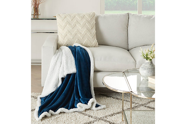 Stay warm and toasty with this fluffy sherpa fleece throw blanket from mina victory home accents. Handmade in a navy blue tone, it reverses to a velvet back for two looks in one. Drape over the corner of your living room couch or at the foot of your bed for an extra-inviting look. This throw is large enough to use as a blanket and stylish enough to use as an accent piece.Handcrafted from 100% polyester | Sherpa fleece | Reverses to poly velvet | Imported