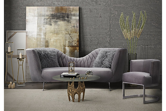 Hollywood glam takes on a whole new meaning when the Eva collection makes its way into your home. We went all out on these statement pieces with intricate details, sloping silhouettes, with soft and sumptuous velvet upholstery. Available in blush or grey, these accent chairs beautifully complement the matching sofa.Handmade by skilled furniture craftsmen | Soft and sumptuous velvet upholstery | Stylish stainless steel legs | Compliments the matching sofa | Ships assembled | Fabric swatch available