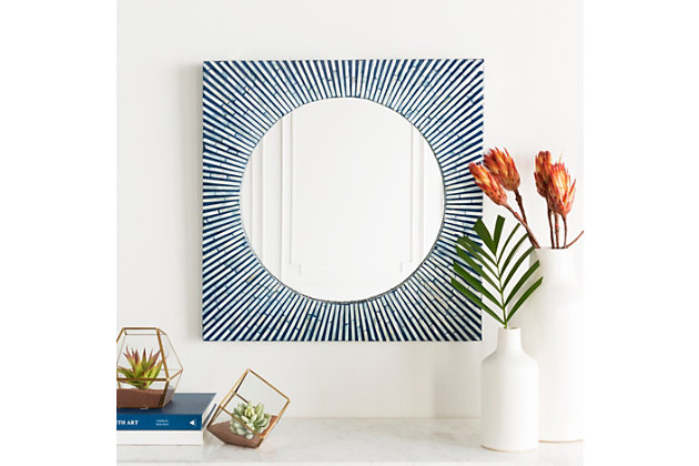 Give the room a cool touch with a sunburst of aqua rays. The home accents blue mother of pearl square mirror radiates with brilliant lines of blue and ivory. Its modern style incorporates a round centered mirror within a square frame of rays for a dynamic effect—what a welcoming sight.D-ring hanger | For indoor/outdoor use | Uv resistant; water resistant | Made of engineered wood | Light blue and white finish | Spot clean only