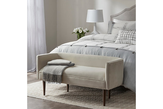 The Madison Park Farrah Accent Bench offers a fashionably unique update to your living room or entryway. This accent bench is upholstered in a rich cream-colored velvet fabric and features a low back and sides for a chic, transitional look. Solid wood legs flaunt a dark brown finish that adds a bold contrast to the upholstery.Made with wood | Legs with dark brown finish | Polyester upholstery | Foam filling | Assembly required