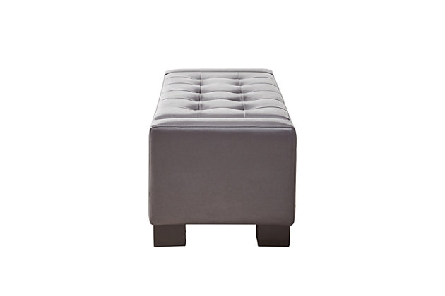 Covered in decadent faux leather upholstery, the handsome button-tufted design of the Mirage Storage Bench is a must-have. The top lifts to reveal extra storage space, making this classy accent both fashionable and functional. Made with wood | Polyester upholstery | Foam filling | Storage space under lift top | Tufted detailing