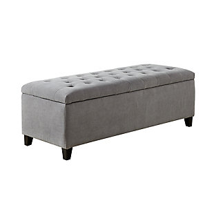 The modern Shandra Storage Bench organizes linens and impresses with its stylish details. Featuring an elegant gray fabric with rich black legs, it provides the perfect functional finishing touch for your space. Made with wood | Legs with black finish | Polyester upholstery | High-density foam filling | Button-tufted detailing | Interior storage
