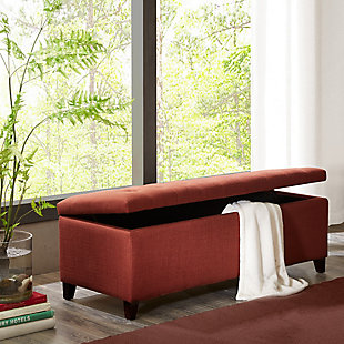 The modern Shandra Storage Bench organizes linens and impresses with its stylish details. Featuring an elegant rust red fabric with rich espresso-hued legs, it provides the perfect functional finishing touch for your space. Made with wood | Legs with espresso-hued finish | Polyester/acrylic upholstery | High-density foam filling | Button-tufted detailing | Interior storage