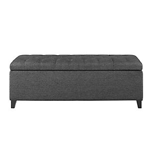 The modern Shandra Storage Bench both organizes linens and impresses with its stylish details. Featuring an elegant gray textured fabric with rich black legs, it provides the perfect functional finishing touch for your space. Made with wood | Legs with black finish | Polyester upholstery | High-density foam filling | Button-tufted detailing | Interior storage