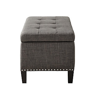 The modern Shandra II Storage Bench organizes linens and impresses with its stylish details. Featuring an elegant gray linen fabric with black noir legs, it provides the perfect functional finishing touch for your space. Made with wood | Legs with black finish | Polyester upholstery | High-density foam filling | Silvertone nailhead trim | Button-tufted detailing | Interior storage