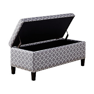 The modern Shandra II Storage Bench organizes linens and impresses with its stylish details. Featuring an elegant gray fretwork fabric with black noir legs, it provides the perfect functional finishing touch for your space. Made with wood | Legs with black finish | Polyester upholstery | High-density foam filling | Silvertone nailhead trim | Button-tufted detailing | Interior storage