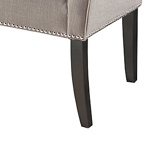 Accent your home with the simple elegance of the Madison Park Welburn Accent Bench. Upholstered in a gray fabric, it features a low back and flared arms that create a sleek and sophisticated look. Bronze-tone nailhead trim adds elegance, while the wood finish complements its upholstery. Perfect for your bedroom or living room, this upholstered bench provides a chic update to your home decor. Made with wood | Legs with Morocco finish | Polyester/linen upholstery | Foam filling | Bronze-tone nailhead trim | Low back and arms