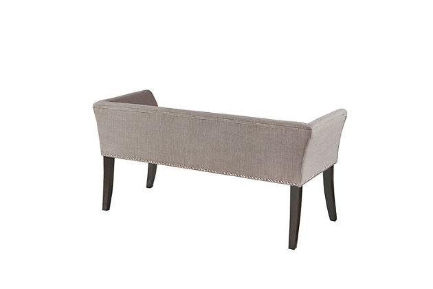 Accent your home with the simple elegance of the Madison Park Welburn Accent Bench. Upholstered in a gray fabric, it features a low back and flared arms that create a sleek and sophisticated look. Bronze-tone nailhead trim adds elegance, while the wood finish complements its upholstery. Perfect for your bedroom or living room, this upholstered bench provides a chic update to your home decor. Made with wood | Legs with Morocco finish | Polyester/linen upholstery | Foam filling | Bronze-tone nailhead trim | Low back and arms
