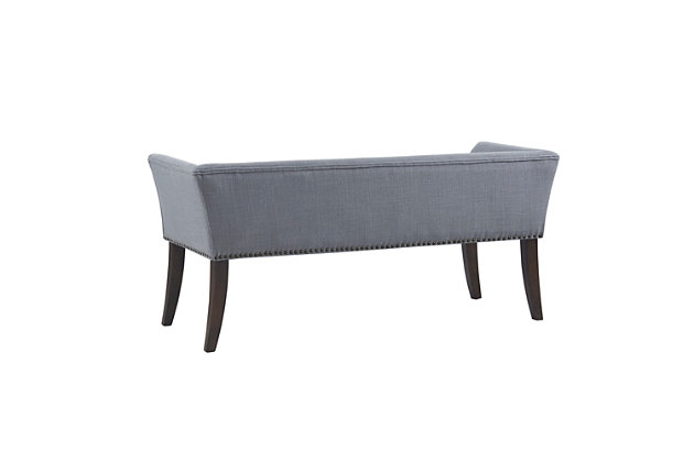 Accent your home with the simple elegance of the Madison Park Welburn Accent Bench. Upholstered in a slate blue fabric, it features a low back and flared arms that create a sleek and sophisticated look. Bronze-tone nailhead trim adds elegance, while the wood finish complements its upholstery. Perfect for your bedroom or living room, this upholstered bench provides a chic update to your home decor. Made with wood | Legs with dark coffee-colored finish | Polyester/linen upholstery | Foam filling | Bronze-tone nailhead trim | Low back and arms