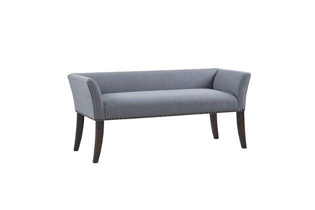 Accent your home with the simple elegance of the Madison Park Welburn Accent Bench. Upholstered in a slate blue fabric, it features a low back and flared arms that create a sleek and sophisticated look. Bronze-tone nailhead trim adds elegance, while the wood finish complements its upholstery. Perfect for your bedroom or living room, this upholstered bench provides a chic update to your home decor. Made with wood | Legs with dark coffee-colored finish | Polyester/linen upholstery | Foam filling | Bronze-tone nailhead trim | Low back and arms