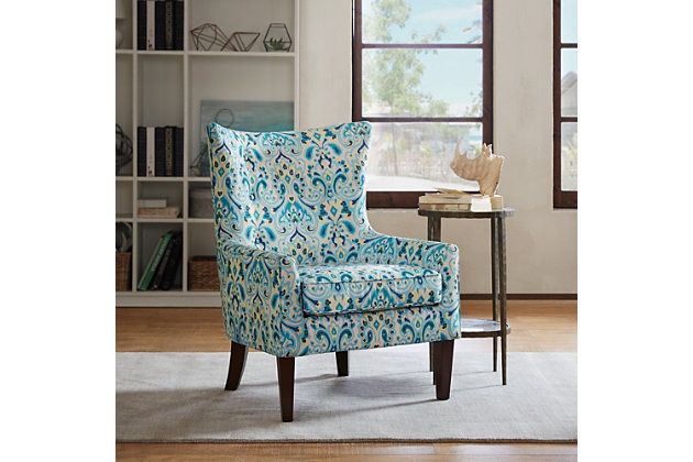 The Carissa Shelter Wing Chair's reinterpretation of the wingback is a refined new classic. Sheltering wings create narrow arms with subtle tufting accents, while the colorful print upholstery gives this chair added appeal.Made with wood | Legs with espresso-hued finish | Polyester upholstery | High-density foam filling | Tight back, loose seat | Button tufting | Assembly required