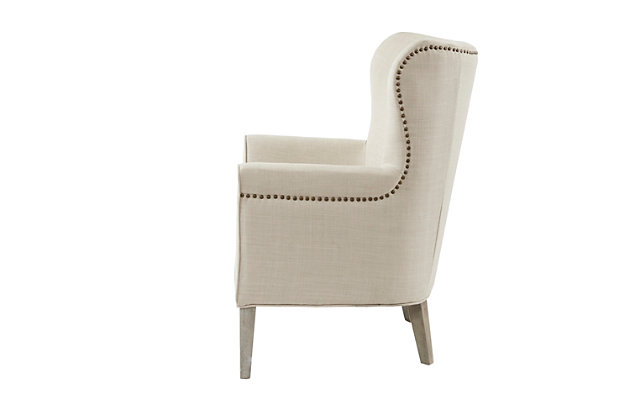 Make a statement in your living room with the Madison Park Colette Accent Chair. The high back and track arms of this stylish accent chair create an elegant silhouette, while the natural-hued upholstery pairs easily with existing decor. Brass-tone nailhead trim and a reclaimed wood finish on the legs beautifully complement the transitional look.Made with wood | Legs with reclaimed natural finish | Polyester upholstery | High-density foam filling | Brass-tone nailhead trim | High-back construction | Weight capacity 300 lbs. | Assembly required