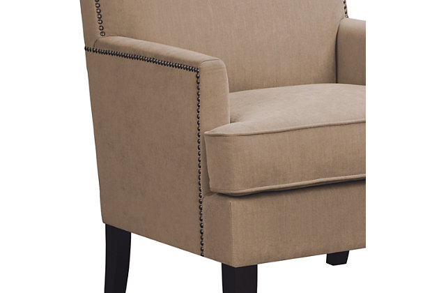 The track arm Colton Club Chair is sure to impress with its sleek contemporary lines, exposed wood legs and nailhead trim. It provides a charming new spin on the classic living room, making it a must-have for modern homemakers.Made with wood | Legs with merlot-hued finish | Polyester upholstery | High-density foam filling | Bronze-tone nailhead trim | Tight back, loose seat | Assembly required