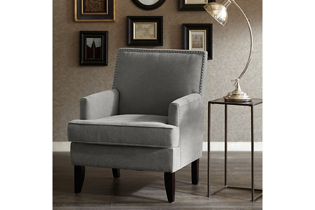 The track arm Colton Club Chair is sure to impress with its sleek contemporary lines, exposed wood legs and nailhead trim. It provides a charming new spin on the classic living room, making it a must-have for modern homemakers.Made with wood | Legs with merlot-hued finish | Polyester upholstery | High-density foam filling | Silvertone nailhead trim | Tight back, loose seat | Assembly required