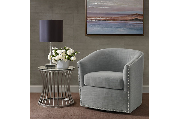 Relax in style with the Madison Park Tyler Swivel Chair. Its curved design and high-density foam cushion create a deep and comfortable seat, allowing for instant relaxation. Silvertone nailheads lining the arms and back add charm and style, while the swivel feature allows for easy mobility. Upholstered in a rich gray fabric, this swivel chair fits in any room of your home.Made with wood | Metal base with black finish | Polyester/linen upholstery | High-density foam filling | Silvertone nailhead trim | 360-degree swivel