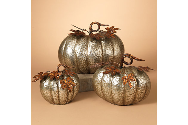 The perfect Thanksgiving season accessory, this nested trio of hammered metal pumpkins add a festive look anyone will be thankful for! Metal’s hammered effect infuses rich texture and a realistic sensibility. Bronze-tone accents enhance the aesthetic beautifully.Set of 3 | Made of metal | Hammered silvertone finish