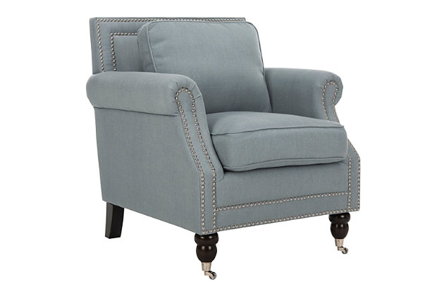 Timeless, elegant and perfect for a casual lifestyle, the classic Karsen club chair by Safavieh is upholstered in a linen and cotton blend in seaside blue with rolled arms, plump seat and back cushions and beautifully turned birch legs finished in espresso.  Silvertone nailhead detailing and front casters add to this chair’s easy-going transitional style.Made with birch wood, stainless steel, polyester/cotton/linen fabric and soft polyfill | Blue upholstery | Espresso finish on legs | Silvertone nailhead trim | Front casters | Assembly required