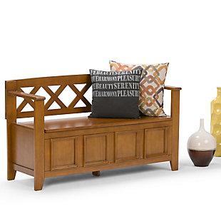 The Amherst storage bench, made from solid wood, allows your inner designer to shine through while creating added storage and seating for your entryway or mudroom. "Form follows function" design rules apply here as the bench features a convenient flip up lid allowing for easy retrieval of articles from the dual storage compartment below.Made of solid wood | Light Avalon brown finish with a protective NC lacquer to accentuate and highlight the wood grain | Lift up lid that opens using safety hinges to expose 2 large internal storage compartments | Library framed square front panels; X-back and side design | Seats 2 comfortably | Assembly required | 1-year warranty