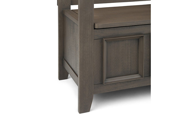 The Amherst storage bench, made from solid wood, allows your inner designer to shine through while creating added storage and seating for your entryway or mudroom. "Form follows function" design rules apply here as the bench features a convenient flip up lid allowing for easy retrieval of articles from the dual storage compartment below.Made of solid wood | Farmhouse gray finish and a protective NC lacquer | Lift up bench lid opens using safety hinges to expose 2 large internal storage compartments | Library framed square front panels; X-back and side design | Seats 2 comfortably | Assembly required | 1-year warranty