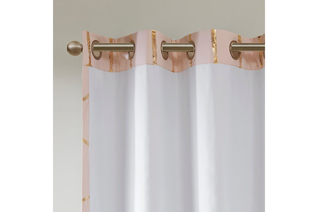 Freshen up your space with the enchanting style of Intelligent Design Raina Window Panel. The stunning panel flaunts a geometric, metallic gold print against a light blush ground for a fun and eye-catching look! Finished with a heavy 3 pass foamback liner, this panel is 100% total blackout providing energy efficiency and added privacy. Grommet top makes this panel easy to hang, open, and close through the day. Machine washable for easy care; complete the collection with coordinating bedding and shower curtain sold separately.Imported | Stylish and practical total blackout curtain panel in metallic print | Energy efficient, block noise intrusion and maximum privacy | Feature 3 pass foamback blackout liner to block sunlight and all lights | Silver grommet top that fits up to 1.25 inches rod in diameter | Need to purchase 2 curtain panels for each window | Machine washable for easy care