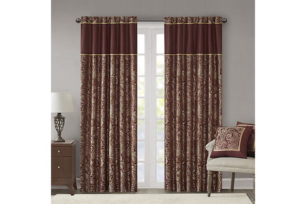 For a luxuriously classic style, our Madison Park Aubrey Window Curtain Pair is the perfect touch to your decor. The alluring jacquard weave is inspired from an updated paisley motif and is woven in beautiful hues of burnt red, gold, and a hint of platinum for a shimmering accent. The window panels are pieced with solid faux silk and beautiful flat piping details in gold, creating an elegant look. Simply hang on rod pocket or back tabs for a tailored finish; fits up to a 1.25 diameter rod.Imported | 100% polyester panel pair | Faux silk light sheen base fabric for light filtering | Paisley jacquard weave design curtains | Rod pocket and back tabs top finish with pieced and piping details | Machine wash for easy care