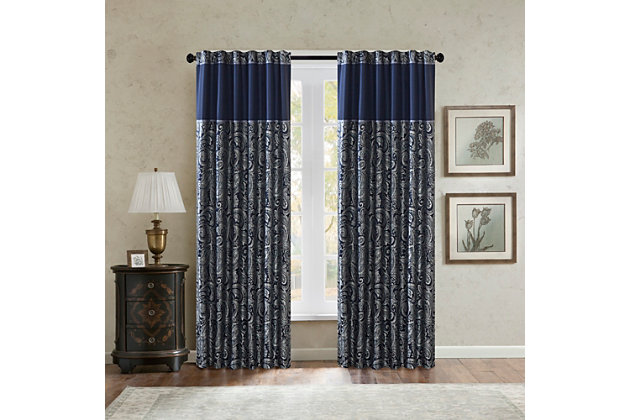 For a luxuriously classic style, our Madison Park Aubrey Window Curtain Pair is the perfect touch to your decor. The alluring jacquard weave is inspired from an updated paisley motif and is woven in beautiful hues of navy, ivory, and a hint of silver for a shimmering accent. The window panels are pieced with solid faux silk and beautiful flat piping details in gold, creating an elegant look. Simply hang on rod pocket or back tabs for a tailored finish; fits up to a 1.25 diameter rod.Imported | 100% polyester panel pair | Faux silk light sheen base fabric for light filtering | Paisley jacquard weave design curtains | Rod pocket and back tabs top finish with pieced and piping details | Machine wash for easy care