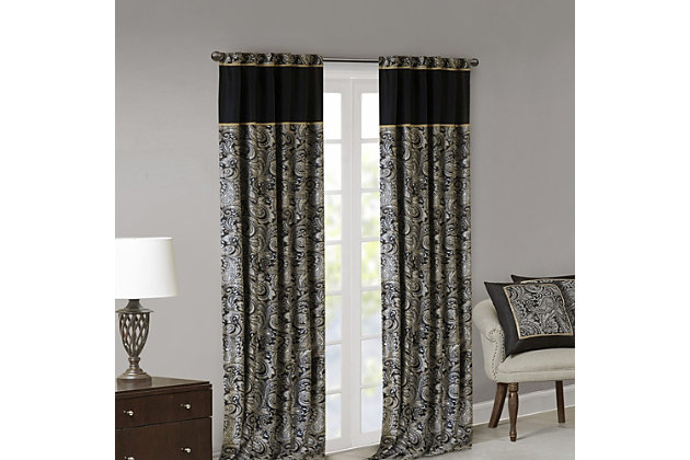 For a luxuriously classic style, our Madison Park Aubrey Window Curtain Pair is the perfect touch to your decor. The alluring jacquard weave is inspired from an updated paisley motif and is woven in beautiful hues of black, gold, and a hint of platinum for a shimmering accent. The window panels are pieced with solid faux silk and beautiful flat piping details in gold, creating an elegant look. Simply hang on rod pocket or back tabs for a tailored finish; fits up to a 1.25 diameter rod.Imported | 100% polyester panel pair | Faux silk light sheen base fabric for light filtering | Paisley jacquard weave design curtains | Rod pocket and back tabs top finish with pieced and piping details | Machine wash for easy care