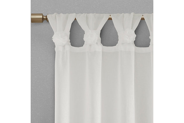 Simple and feminine in all the right ways, Madison Park Rosette Tab Top Solid Window Panel Embellished with Flower offers a gorgeous one-of-a-kind look to your home. This solid white panel features a tab top finish and beautiful removable floral pins that give your room a decorator’s touch. The lightweight faux linen semi-sheer fabric filters the perfect amount of light into your home,  while creating a soft airy feel - for the perfect shabby chic update to your decor. Window panel is machine washable for easy care, while floral pins are spot clean only. Fits up to a 2" diameter rod.Imported | Tab top curtains that can fit up to 2"" diameter rod | Removable floral pins for decorators touch | Lightweight faux linen sheer base for natural look and feel | Shabby chic home decor | Available in 63, 84 or 95 inches in length curtain panel | Need to buy 2 panels for each window | Machine washable for easy care - remove all flowers before machine washing