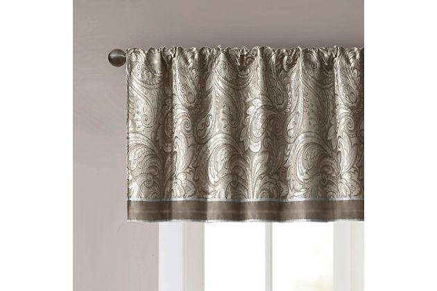 For a luxuriously classic style, our Madison Park Aubrey Window Valance is the perfect touch to your decor. The alluring jacquard weave is inspired from an updated paisley motif and is woven in beautiful hues of blue, taupe, and a hint of platinum for a shimmering accent. The window valance are pieced with solid faux silk and beautiful flat piping details in gold, creating an elegant look. Simply hang on rod pocket; fits up to a 1.25 diameter rod.Imported | Paisley jacquard weave design | Pieced border detailing | Rod pocket top finish