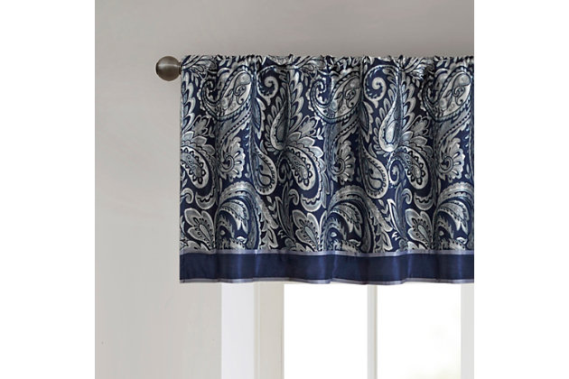 For a luxuriously classic style, our Madison Park Aubrey Window Valance is the perfect touch to your decor. The alluring jacquard weave is inspired from an updated paisley motif and is woven in beautiful hues of navy, ivory, and a hint of silver for a shimmering accent. The window valance are pieced with solid faux silk and beautiful flat piping details in gold, creating an elegant look. Simply hang on rod pocket; fits up to a 1.25 diameter rod.Imported | Paisley jacquard weave design | Pieced border detailing | Rod pocket top finish