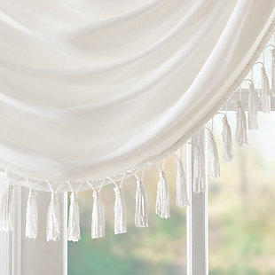 Bring style and sophistication to your windows, with our Elena Waterfall window valance. This classy white valance showcases rich center draping details and a beautiful tassel trim, combined with the faux silk fabric for a rich sheen and stylish update. Features added lining and a rod pocket top finish; fits up to 1.25" diameter rod. Part of our decorative valance collection, this valance is perfect as a stylish addition to any small window or even better as a layering piece to dress up any window panel. This window valance is also OEKO-TEX certified, meaning it does not contain any harmful substances or chemicals, ensuring quality comfort and wellness. Multiple valances used to create this look.Imported | Faux silk luxe light sheen fabric window valance | Center waterfall drape design | Fits up 1.25" diameter rod | Tassel trim embellishment detailing | Oeko-tex certified, includes no harmful substances or chemicals (# bj025 173578) | Added lining for finish touch | Coordinating window panel available and sold separately | Machine washable for easy care