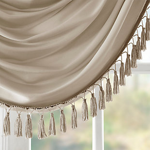 Bring style and sophistication to your windows, with our Elena Waterfall window valance. This classy champagne valance showcases rich center draping details and a beautiful tassel trim, combined with the faux silk fabric for a rich sheen and stylish update. Features added lining and a rod pocket top finish; fits up to 1.25" diameter rod. Part of our decorative valance collection, this valance is perfect as a stylish addition to any small window or even better as a layering piece to dress up any window panel. This window valance is also OEKO-TEX certified, meaning it does not contain any harmful substances or chemicals, ensuring quality comfort and wellness. Multiple valances used to create this look.Imported | Faux silk luxe light sheen fabric window valance | Center waterfall drape design | Fits up 1.25" diameter rod | Tassel trim embellishment detailing | Oeko-tex certified, includes no harmful substances or chemicals (# bj025 173578) | Added lining for finish touch | Coordinating window panel available and sold separately | Machine washable for easy care