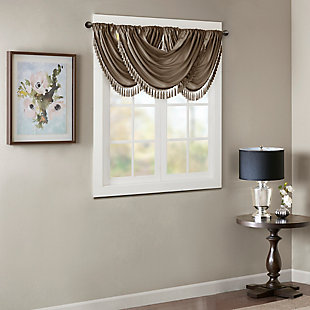 Bring style and sophistication to your windows, with our Elena Waterfall window valance. This classy bronze valance showcases rich center draping details and a beautiful tassel trim, combined with the faux silk fabric for a rich sheen and stylish update. Features added lining and a rod pocket top finish; fits up to 1.25" diameter rod. Part of our decorative valance collection, this valance is perfect as a stylish addition to any small window or even better as a layering piece to dress up any window panel. This window valance is also OEKO-TEX certified, meaning it does not contain any harmful substances or chemicals, ensuring quality comfort and wellness. Multiple valances used to create this look.Imported | Faux silk luxe light sheen fabric window valance | Center waterfall drape design | Fits up 1.25" diameter rod | Tassel trim embellishment detailing | Oeko-tex certified, includes no harmful substances or chemicals (# bj025 173578) | Added lining for finish touch | Coordinating window panel available and sold separately | Machine washable for easy care