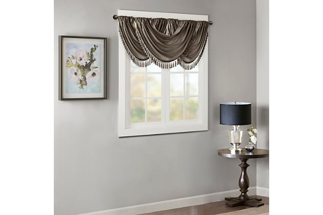 Bring style and sophistication to your windows, with our Elena Waterfall window valance. This classy pewter valance showcases rich center draping details and a beautiful tassel trim, combined with the faux silk fabric for a rich sheen and stylish update. Features added lining and a rod pocket top finish; fits up to 1.25" diameter rod. Part of our decorative valance collection, this valance is perfect as a stylish addition to any small window or even better as a layering piece to dress up any window panel. This window valance is also OEKO-TEX certified, meaning it does not contain any harmful substances or chemicals, ensuring quality comfort and wellness. Multiple valances used to create this look.Imported | Faux silk luxe light sheen fabric window valance | Center waterfall drape design | Fits up 1.25" diameter rod | Tassel trim embellishment detailing | Oeko-tex certified, includes no harmful substances or chemicals (# bj025 173578) | Added lining for finish touch | Coordinating window panel available and sold separately | Machine washable for easy care