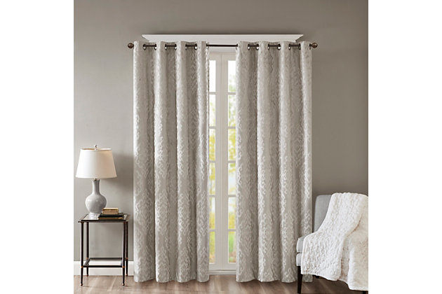 Give your home the lavish style and energy efficiency it deserves with our SunSmart Mirage Knitted Jacquard Total Blackout Panel. This elegant window panel flaunts a knitted jacquard damask design in a rich grey hue, creating a luxurious sheen and texture. The heavyweight fabric features a foam-back and bonding finish that blocks out all sunlight and provides a maximum protective barrier against noise intrusion. With 100% total blackout properties, this window panel offers a maximum level of privacy and energy savings, which makes it perfect for bedrooms, media rooms, or any private spaces. A silver grommet top detail completes the look, while also making it easy to hang, open, and close the window panel throughout the day. Fits up to a 1.25” diameter rod. Lighting level: Pitch Black Ambiance.Imported | Total blackout grommet top curtain panel in knitted jacquard damask design | Heavy weight fabric in foamback bonding finish on the reverse side | Block out all sunlight and exterior light | Silver grommet top that fits up to 1.25 inches rod in diameter | Maximum level of privacy, energy saving and block noise intrusion | Great for bedroom, media room or any private space | Need to purchase 2 curtain panels for each window | Machine washable