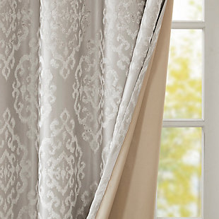 Give your home the lavish style and energy efficiency it deserves with our SunSmart Mirage Knitted Jacquard Total Blackout Panel. This elegant window panel flaunts a knitted jacquard damask design in a rich grey hue, creating a luxurious sheen and texture. The heavyweight fabric features a foam-back and bonding finish that blocks out all sunlight and provides a maximum protective barrier against noise intrusion. With 100% total blackout properties, this window panel offers a maximum level of privacy and energy savings, which makes it perfect for bedrooms, media rooms, or any private spaces. A silver grommet top detail completes the look, while also making it easy to hang, open, and close the window panel throughout the day. Fits up to a 1.25” diameter rod. Lighting level: Pitch Black Ambiance.Imported | Total blackout grommet top curtain panel in knitted jacquard damask design | Heavy weight fabric in foamback bonding finish on the reverse side | Block out all sunlight and exterior light | Silver grommet top that fits up to 1.25 inches rod in diameter | Maximum level of privacy, energy saving and block noise intrusion | Great for bedroom, media room or any private space | Need to purchase 2 curtain panels for each window | Machine washable