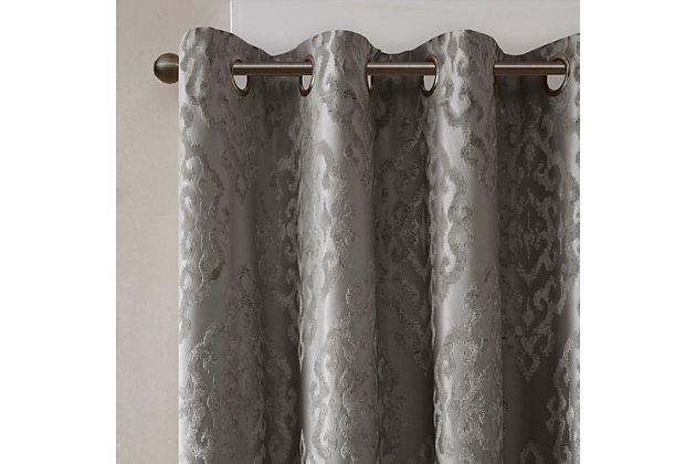 Give your home the lavish style and energy efficiency it deserves with our SunSmart Mirage Knitted Jacquard Total Blackout Panel. This elegant window panel flaunts a knitted jacquard damask design in a rich charcoal hue, creating a luxurious sheen and texture. The heavyweight fabric features a foam-back and bonding finish that blocks out all sunlight and provides a maximum protective barrier against noise intrusion. With 100% total blackout properties, this window panel offers a maximum level of privacy and energy savings, which makes it perfect for bedrooms, media rooms, or any private spaces. A gunmetal grommet top detail completes the look, while also making it easy to hang, open, and close the window panel throughout the day. Fits up to a 1.25” diameter rod. Lighting level: Pitch Black Ambiance.Imported | Total blackout grommet top curtain panel in knitted jacquard damask design | Heavy weight fabric in foamback bonding finish on the reverse side | Block out all sunlight and exterior light | Silver grommet top that fits up to 1.25 inches rod in diameter | Maximum level of privacy, energy saving and block noise intrusion | Great for bedroom, media room or any private space | Need to purchase 2 curtain panels for each window | Machine washable
