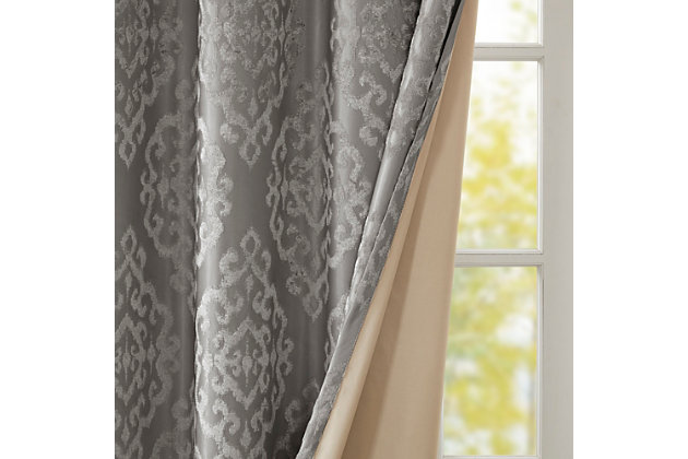 Give your home the lavish style and energy efficiency it deserves with our SunSmart Mirage Knitted Jacquard Total Blackout Panel. This elegant window panel flaunts a knitted jacquard damask design in a rich charcoal hue, creating a luxurious sheen and texture. The heavyweight fabric features a foam-back and bonding finish that blocks out all sunlight and provides a maximum protective barrier against noise intrusion. With 100% total blackout properties, this window panel offers a maximum level of privacy and energy savings, which makes it perfect for bedrooms, media rooms, or any private spaces. A gunmetal grommet top detail completes the look, while also making it easy to hang, open, and close the window panel throughout the day. Fits up to a 1.25” diameter rod. Lighting level: Pitch Black Ambiance.Imported | Total blackout grommet top curtain panel in knitted jacquard damask design | Heavy weight fabric in foamback bonding finish on the reverse side | Block out all sunlight and exterior light | Silver grommet top that fits up to 1.25 inches rod in diameter | Maximum level of privacy, energy saving and block noise intrusion | Great for bedroom, media room or any private space | Need to purchase 2 curtain panels for each window | Machine washable