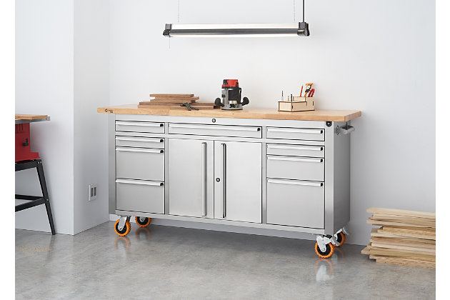 This adjustable height rolling workbench is built with a solid wood top that can be raised and lowered with the simple turn of a crank. The adjustable height provides ergonomic comfort to help reduce strain and discomfort while standing or sitting for long periods. The heavy-duty fingerprint-resistant stainless steel construction provides the strength and durability to handle the toughest jobs. The rubberwood top is designed with a overhang on both sides to mount a vise. The construction of this workbench is professional-grade and designed to meet the needs of experts who value high quality and remarkable craftsmanship.Made of stainless steel, rubberwood and aluminum | Fingerprint resistant stainless steel finish | Butcher block top; adjustable height up to 12 inches  | 9 smooth-gliding drawers | Pre-cut drawer liners | Single cabinet with adjustable shelf | Center locking system | Total weight capacity 2,220 pounds on wheels (evenly distributed) | Casters for easy mobility (2 locking; 2 non-locking) | Aluminum drawer pulls with chrome-tone finish | Stainless steel side handles | Minor assembly required