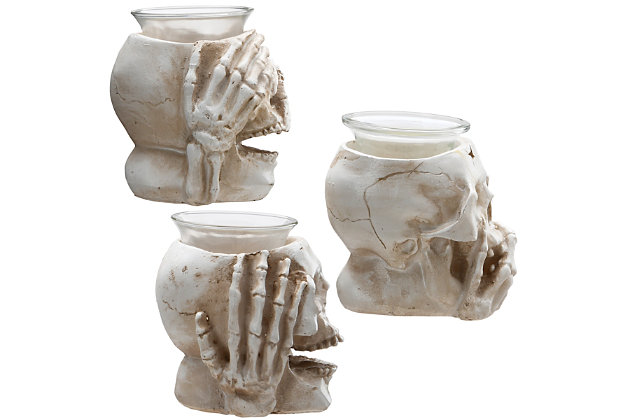 These creepy candleholders each feature a skull with bone hands depicting hear-no-evil, speak-no-evil, see-no-evil expressions. They are constructed of sturdy poly-resin material finished in eerie detail and topped with a glass bowl to hold a tea light style candle. This spooky set will help decorate the scene for Halloween.Set of three | 3.5" height | Halloween-themed tabletop decoration | Constructed of sturdy poly-resin material | Each glass bowl holds a tea light candle