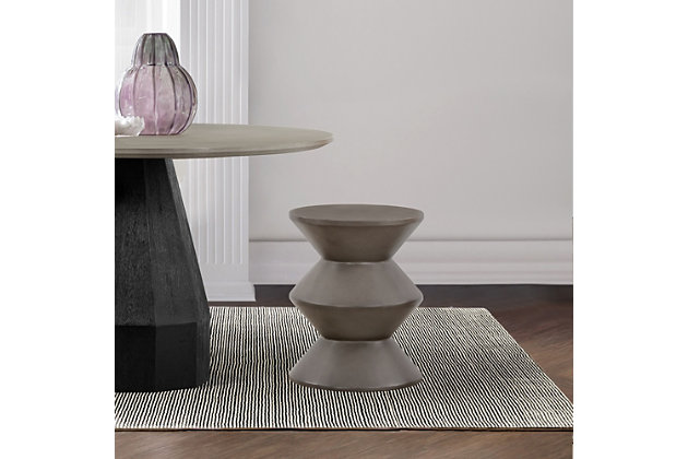 The Lizzie accent stool end table is a wonderfully unique piece that communicates its individuality with its look. The sophisticated texture and bold geometric form create a grand statement in any indoor or outdoor space. The concrete is lightweight, making it easy to move, but is still able to hold a substantial amount of weight. Perfect as an end table in your living space, home office or patio and diverse enough to be used for an impromptu seating option as the seat height is comparable to the average dining chair seat height.Made of concrete | Can be used for display space or extra seating | Simple to clean and easy to maintain; wipe clean