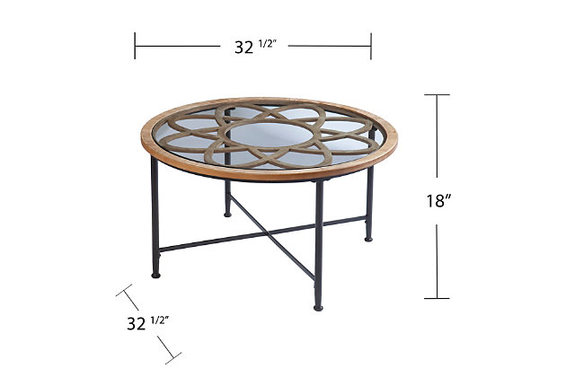 Add unique flair to your living space with this round cocktail table. A spacious glass tabletop offers plenty of room for your serving tray or magazine collection, while the floral-inspired design underneath creates a rustic look. X-shaped crossbars bring a classic feel to your space, highlighting modern farmhouse style in your family room or open concept floorplan. Cross country chic off your list when you bring home this glass-top coffee table.Made with engineered wood, metal and glass | Top with floral design | Modern mixed-material construction | Small space friendly footprint | Assembly required