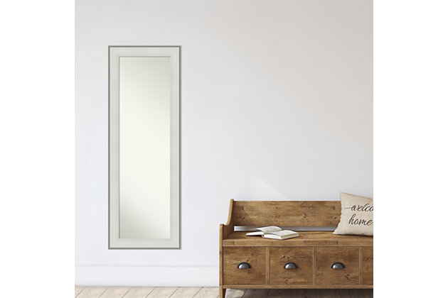 This high-quality full-length mirror complements your decor without the need for unsightly "over the door" brackets. Our On The Door Mirror comes with two hooks to hang directly on your door without additional anchors or brackets. With a 14 x 48" viewing area, it gives you a full image either on the back of a door or on the wall as a standard full-length mirror. This mirror features a matte white frame with an outer ledge and a raised profile that scoops to the inner edge. Amanti Art is headquartered in Madison, WI and provides high quality, handmade framed art, mirrors and organization boards for your home improvement projects. Our home decor products are made using traditional custom framing techniques that give you the kind of quality you'd expect from your local frame shop. Because of our focus on workmanship, our products are used by architects, developers, interior designers and homeowners alike to create beautiful functional living spaces.The imperial white frame is a matte white frame with an outer ledge and a raised profile that scoops to the inner edge. | This mirror works perfectly as a door mirror, full size mirror or large mirror on the wall. This mirror itself is not beveled, for full use of the reflective area. | All amanti art wall mirrors are finished with a paper backing to prevent moisture and dust buildup. | Each mirror has durable d rings attached to the back along with 2 hanging hooks and nails to tap directly into your door or wall. It can be hung on door or horizontally/vertically on the wall. | Amanti art custom frames decorative mirrors and assembles each piece to order in madison, wi.