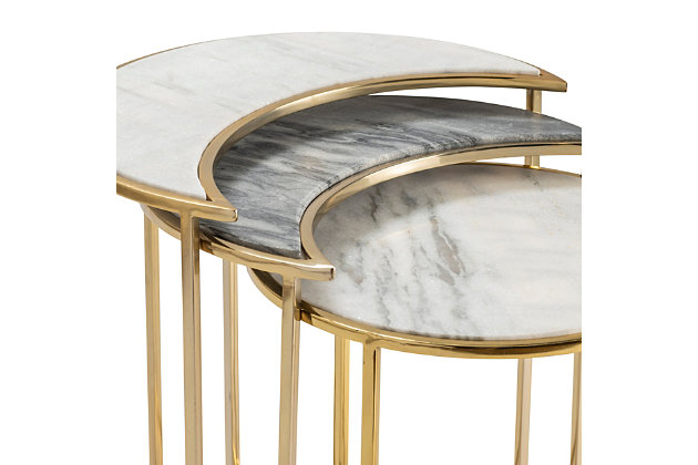Style and function combine to create this set of three Astronomy Nesting Tables by Crestview Collection. Featuring two crescent-shaped tables and one round table, the space-saving design is perfect for contemporary areas. With a circular base crafted from iron in a goldtone finish, each glam table features an updated silhouette that supports a sophisticated marble top. These multicolored, versatile end tables can be nested or used separately to accommodate all your needs.Hand-carved from mango wood | Brown finish | 1 removable lower shelf | Shelf weight capacity: 30 lbs. | Total weight capacity: 50 lbs. | Inside length and width: 18"; inside height: 20" | Leg height from ground: 4" | Teflon protective glides | Wipe clean with a dry cloth | Assembly required | Indoor use only