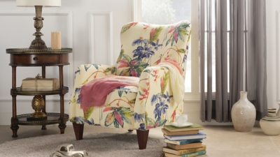 Armchair with tropical print in living room with decor