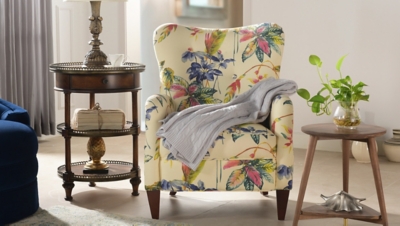 Tropical print upholstered armchair in living room scene