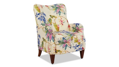 Close-up of tropical print armchair with wooden legs